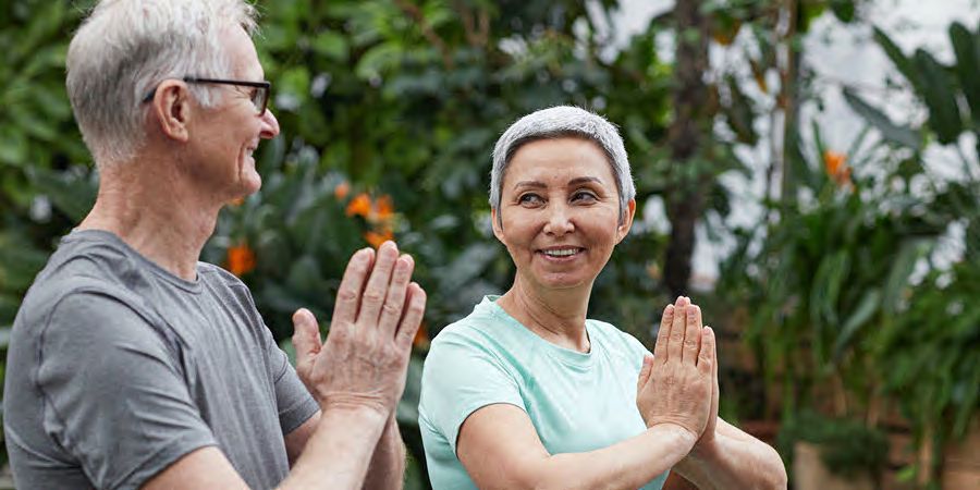 man and woman doing yoga